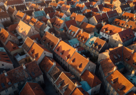 Aerial view of European old town rooftops at golden hour